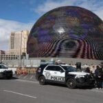 Individuals are seen in handcuffs near the Sphere after law enforcement responded to reports that pro-life activist Maison DesChamps (not pictured) had climbed to the top of the structure on February 07, 2024 in Las Vegas, Nevada.