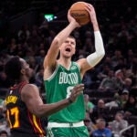 Celtics center Kristaps Porzingis drives to the basket against Atlanta forward Onyeka Okongwu during the first half.