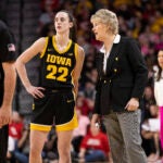 Iowa's Caitlin Clark talks with head coach Lisa Bluder.