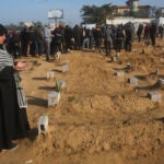 A Palestinian woman prays for a relative killed in the Israeli bombardment of the Gaza Strip.
