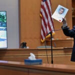 Senior Assistant New Hampshire Attorney General Benjamin Agati shows the jury a photograph of the defendant during closing arguments in Adam Montgomery's trial, Wednesday, Feb. 21, 2024, in Manchester, N.H.