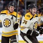 BOSTON, MASSACHUSETTS - JANUARY 20: Jake DeBrusk #74 of the Boston Bruins celebrates with Charlie McAvoy #73 after assisting a goal scored by Pavel Zacha #18 against the Montreal Canadiens during the third period at TD Garden on January 20, 2024 in Boston, Massachusetts. The Bruins defeat the Canadiens 9-4.