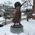 A bronze statue of Pollyanna sits outside the Littleton public library.
