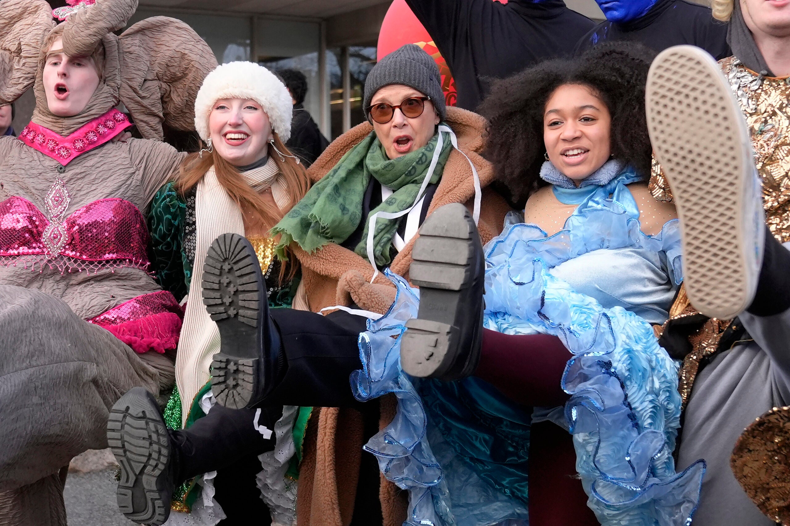 Actor Annette Bening, center, Hasty Pudding 2024 Woman of the Year, dances with Harvard University theatrical students, Tuesday, Feb. 6, 2024, following a parade through Harvard Yard, in Cambridge, Mass. 
