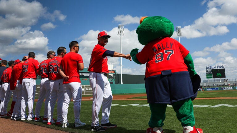 Boston Red Sox manager Alex Cora fist bumps Wally after the playing of the National Anthem. The Boston Red Sox host the Northeastern University Huskies at JetBlue Park at Fenway South. Boston Red Sox Spring Training.