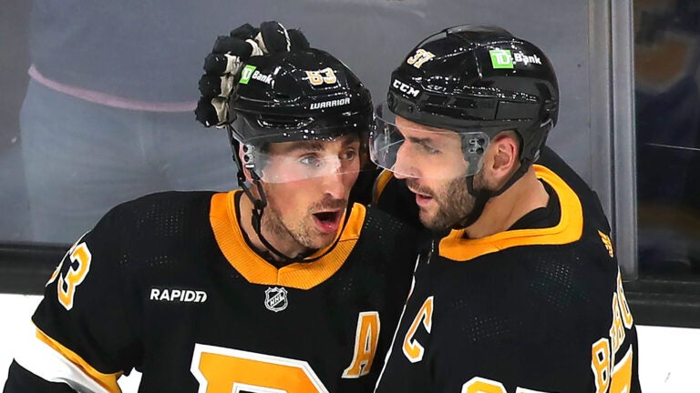 Boston 10/27/22 Boston Bruins vs Detroit Red Wings-Boston Bruins left wing Brad Marchand (63) (left) is congratulated by Boston Bruins center Patrice Bergeron (37) after Marchand’s 3rd period goal.