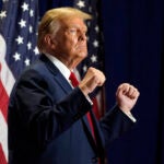 Republican presidential candidate former President Donald Trump gestures at a campaign rally.