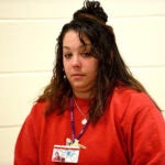 Kayla Montgomery stands and looks over to the gallery after her parole board hearing at the New Hampshire Correctional Facility for Women in Concord, N.H.