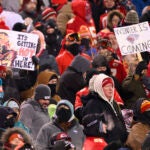 Kansas City Chiefs fans who braved sub-zero temperatures celebrate after a touchdown.
