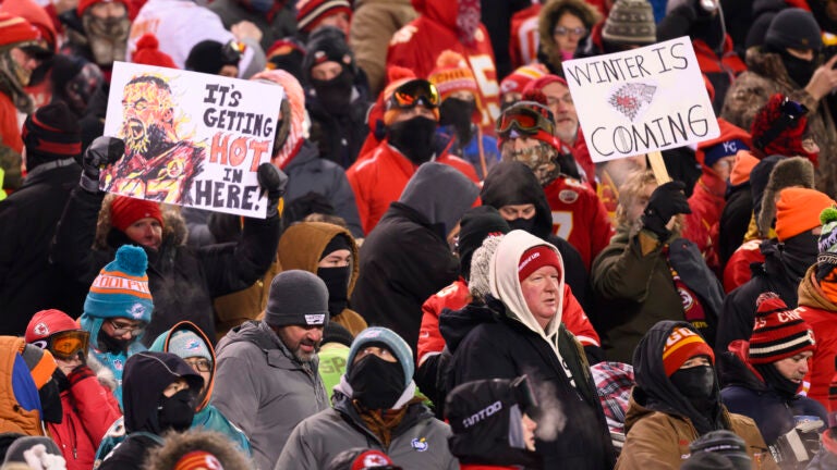 Kansas City Chiefs fans who braved sub-zero temperatures celebrate after a touchdown.