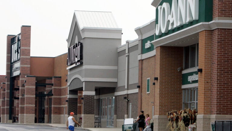 People walk into and out of a Joann store.