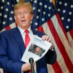 Former President Donald Trump holds up a copy of a story featuring New York Attorney General Letitia James.