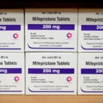 Boxes of the drug mifepristone sit on a shelf.