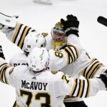 Boston Bruins goaltender Jeremy Swayman (1) celebrates with right wing David Pastrnak (88) and defenseman Charlie McAvoy (73) after the team's shootout win against the Washington Capitals in an NHL hockey game Saturday, March 30 2024, in Washington.
