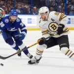 Bruins right wing David Pastrnak works ahead of Tampa Bay Lightning left wing Brandon Hagel during a March 27 game in Tampa, Fla.