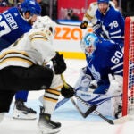 Bruins center Pavel Zacha scores against Toronto goaltender Joseph Woll during third-period.