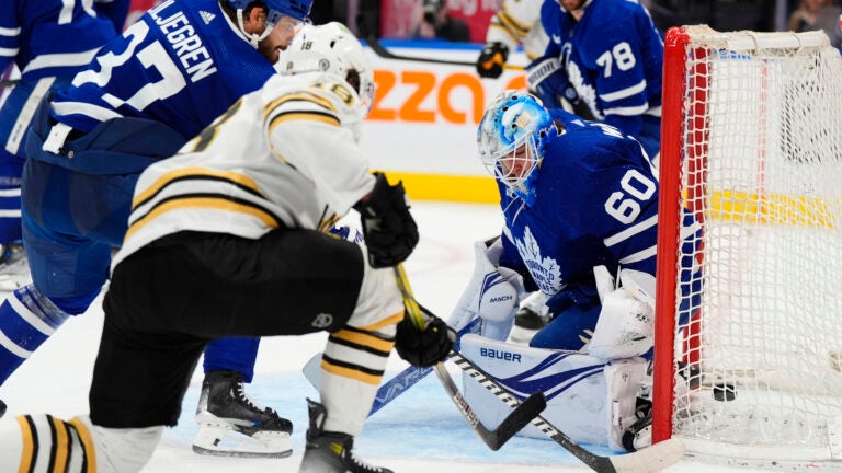 Bruins center Pavel Zacha scores against Toronto goaltender Joseph Woll during third-period.