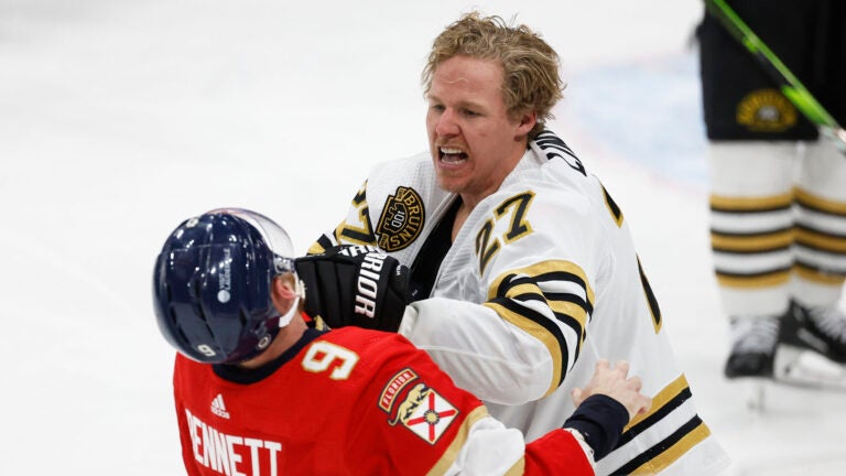 Florida Panthers center Sam Bennett (9) and Boston Bruins defenseman Hampus Lindholm (27) fight during the second period of an NHL hockey game, Tuesday, March 26, 2024, in Sunrise, Fla.