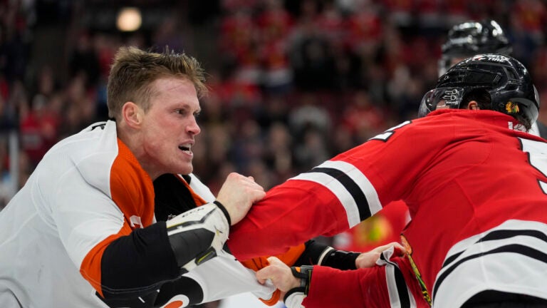 Chicago Blackhawks center Reese Johnson, right, and Philadelphia Flyers defenseman Nick Seeler go at it during the third period of an NHL hockey game Wednesday, Feb. 21, 2024, in Chicago. The Flyers won 3-1.
