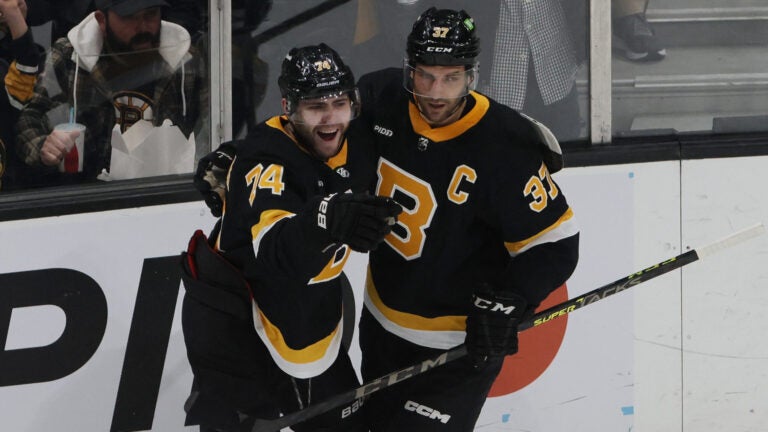 Boston Bruins Jake DeBrusk (L) celebrates his goal against the Ottawa Senators Goalie with teammate Patrice Bergeron during the first period of play at TD Garden.