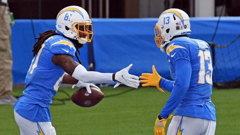 Los Angeles Chargers wide receivers Mike Williams (81) and Keenan Allen (13) celebrate in the end zone after Williams caught a pass for a touchdown during an NFL football game against the New York Jets, Sunday, November 22, 2020 in Inglewood, Calif. The Chargers defeated the Jets 34-28.