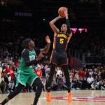 Dejounte Murray of the Atlanta Hawks hits the game-winning basket against Jrue Holiday of the Celtics during overtime.