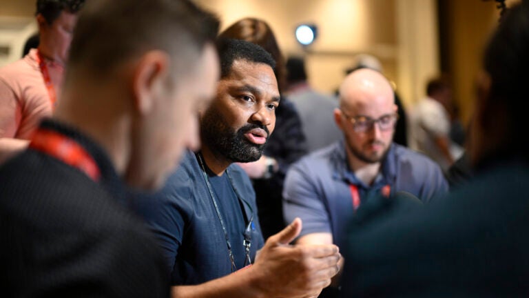 New England Patriots head coach Jerod Mayo, center, talks with reporters during an AFC coaches availability at the NFL owners meetings, Monday, March 25, 2024, in Orlando, Fla.
