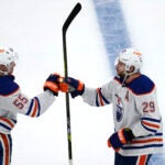 Edmonton Oilers center Leon Draisaitl (29) is congratulated by left wing Dylan Holloway (55) for an overtime goal against the Bruins.