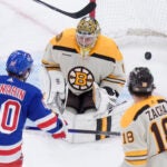 New York Rangers left wing Artemi Panarin hits the puck past Bruins goaltender Jeremy Swayman to score in the second period.