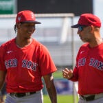 Red Sox pitcher Brayan Bello, left, talks with manager Alex Cora during spring training in Fort Myers, Fla., Thursday, Feb. 15, 2024.