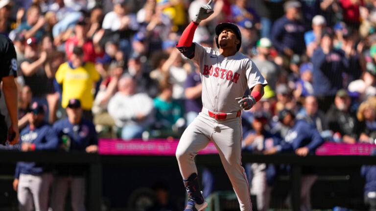 The Red Sox's Enmanuel Valdez celebrates while jogging the bases after hitting a three-run home run against the Seattle Mariners during the fourth inning.
