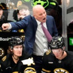 Boston Bruins head coach Jim Montgomery calls to his players during the second period of an NHL hockey game against the Dallas Stars, Monday, Feb. 19, 2024, in Boston.