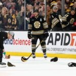 The Bruins' David Pastrnak skates through hats that were thrown on the ice surface after his hat trick against the Ottawa Senators during the third period.
