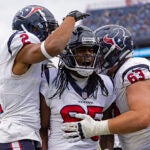 Houston Texans wide receiver Noah Brown (85) celebrates with wide receiver Robert Woods (2), and center Michael Deiter (63) after scoring a touchdown during their NFL football game against the Tennessee Titans Sunday, Dec. 17, 2023, in Nashville, Tenn.