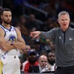WASHINGTON, DC - FEBRUARY 27: Head coach Steve Kerr of the Golden State Warriors (R) and Stephen Curry #30 of the Golden State Warriors look on against the Washington Wizards during the first half at Capital One Arena on February 27, 2024 in Washington, DC.