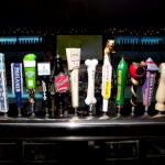Several beer tap handles at a Boston bar.