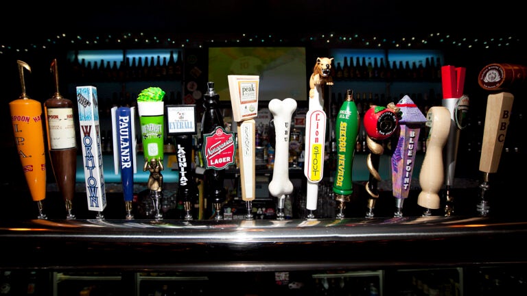 Several beer tap handles at a Boston bar.
