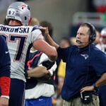 Patriots TE Rob Gronkowski geta a pat on the shoulder from head coach Bill Belichick following a first quarter reception. The New England Patriots visited the Houston Texans in a regular season NFL football game at NRG Stadium.