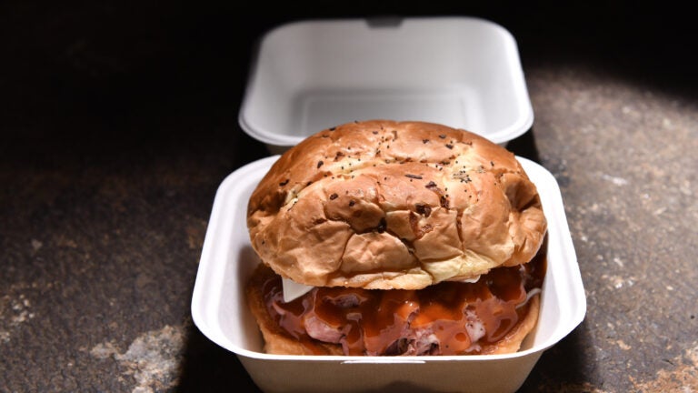A roast beef sandwich in a take-out container.