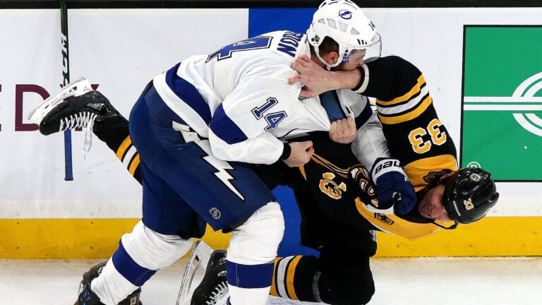 Boston Bruins defenseman Zdeno Chara (33) is wrestled to the ice during his bout with Tampa Bay Lightning left wing Pat Maroon (14) during the second period. The Boston Bruins host the Tampa Bay Lightning at TD Garden.