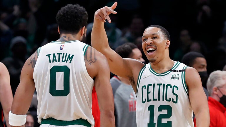 Boston, MA: 03–01-22: The Celtics Grant Williams (12) hit two consecutive three pointers from in front of the Hawks bench, the first gave Boston a 99-88 lead, the second extended the margin to 102-88, essentialy wrapping up the Boston victory. He is pictured celebrating the second bucket with teammate Jayson Tatum (0). The Boston Celtics hosted the Atlanta Hawks in an NBA regular season basketball game at the TD Garden.