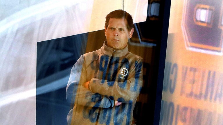 Bruins GM Don Sweeney leans on a beam as he watches the practice from his office. The Boston Bruins held their first day of practice their training camp at the Warrior Ice Arena.