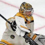 Boston Bruins goaltender Jeremy Swayman (1) makes a stick save in the 3rd period.