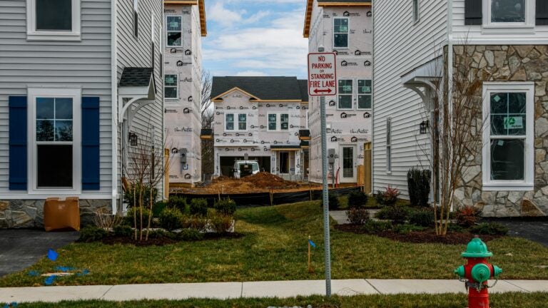 A town home community under construction with exterior wrap showing.