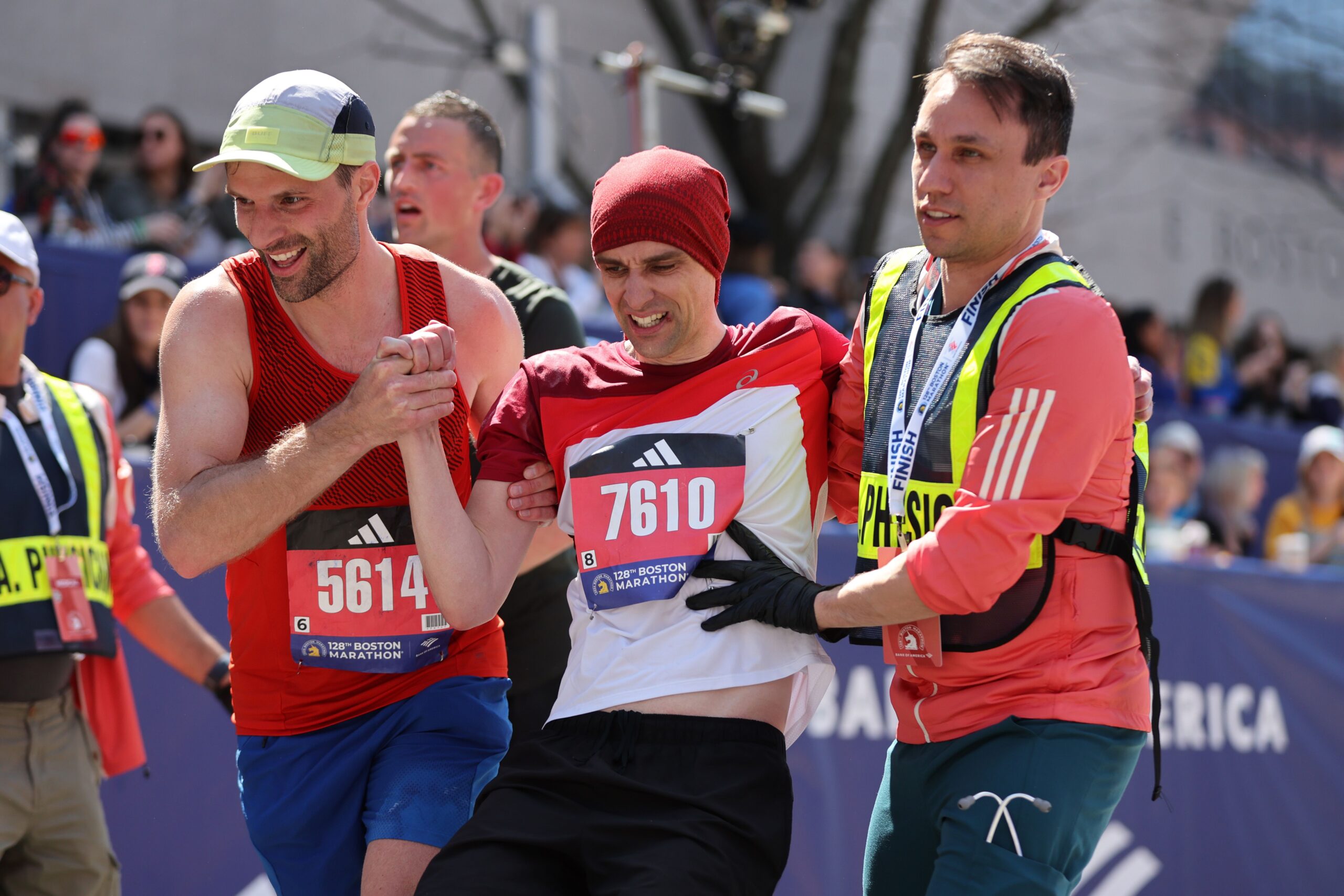 Stefan Gockeln is helped across the finish line during the 128th Boston Marathon on April 15, 2024 in Boston, Massachusetts.