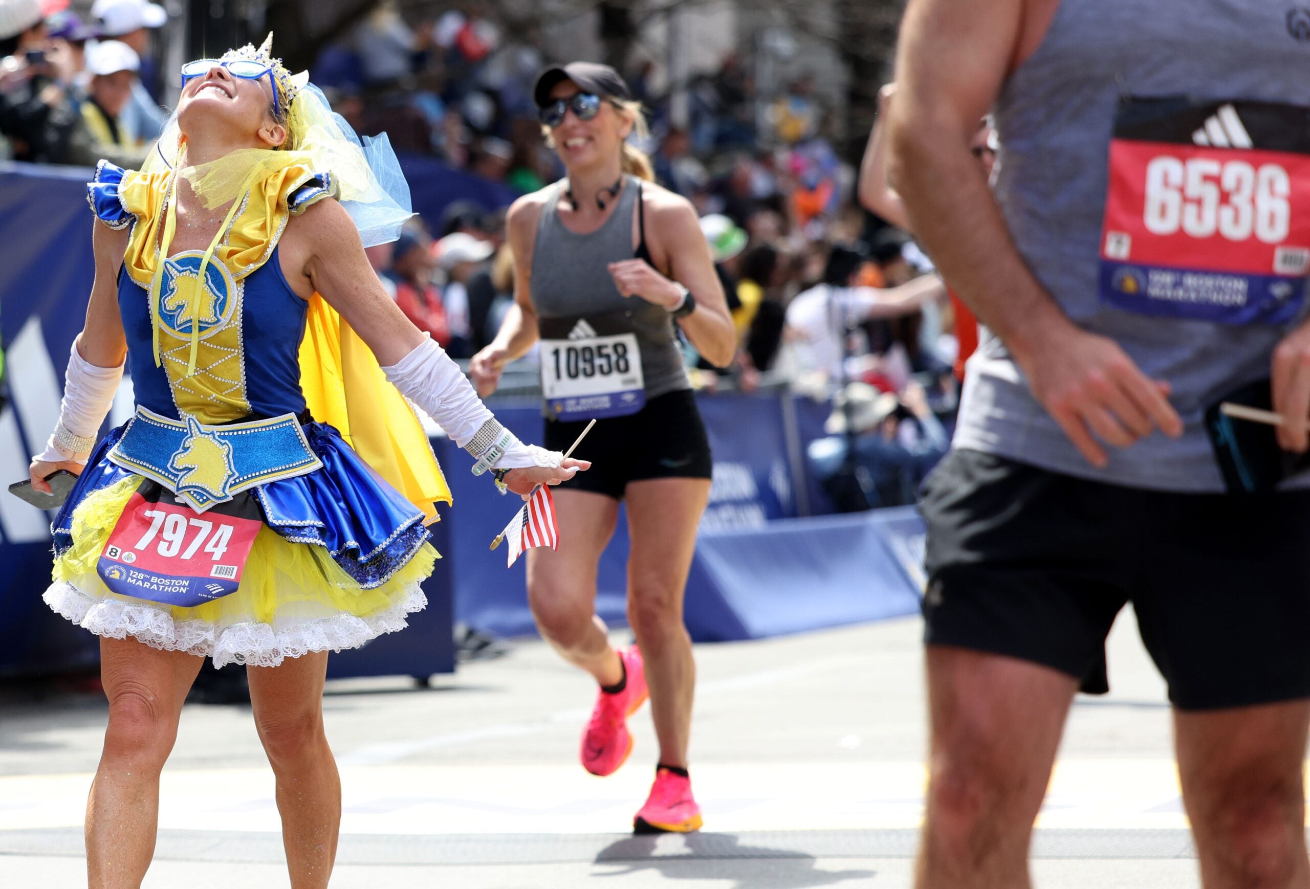 Yuki Chorney (L) celebrated as she crossed the finish line during the Boston Marathon on Monday, April 15, 2024.