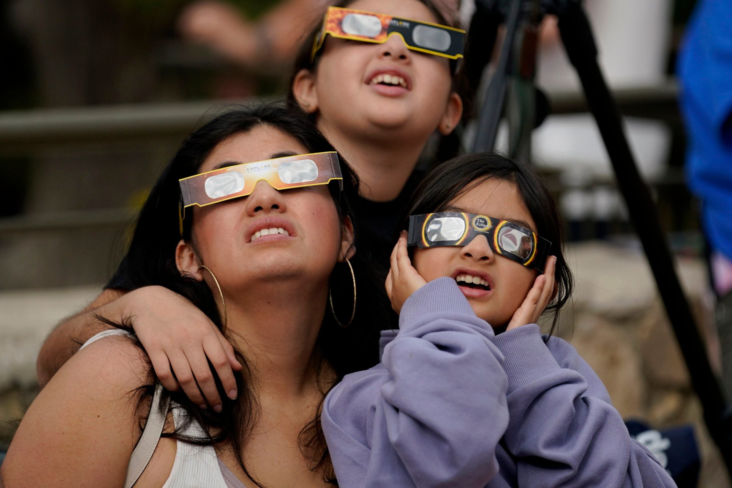 Viewers use special eclipse glasses to watch as the moon moves in front of the sun during an annular solar eclipse on Oct. 14, 2023, in San Antonio, Texas.