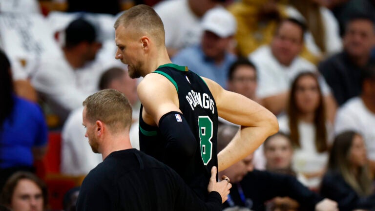 Miami, FL- 4/29/24- Boston Celtics center Kristaps Porzingis (8) walks off the court with an apparent injury during the second quarter in game four of the NBA Eastern Conference Playoffs.