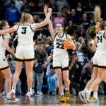 Iowa guard Caitlin Clark (22) celebrates with teammates after defeating LSU.