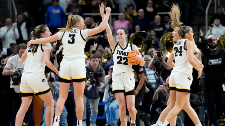 Iowa guard Caitlin Clark (22) celebrates with teammates after defeating LSU.
